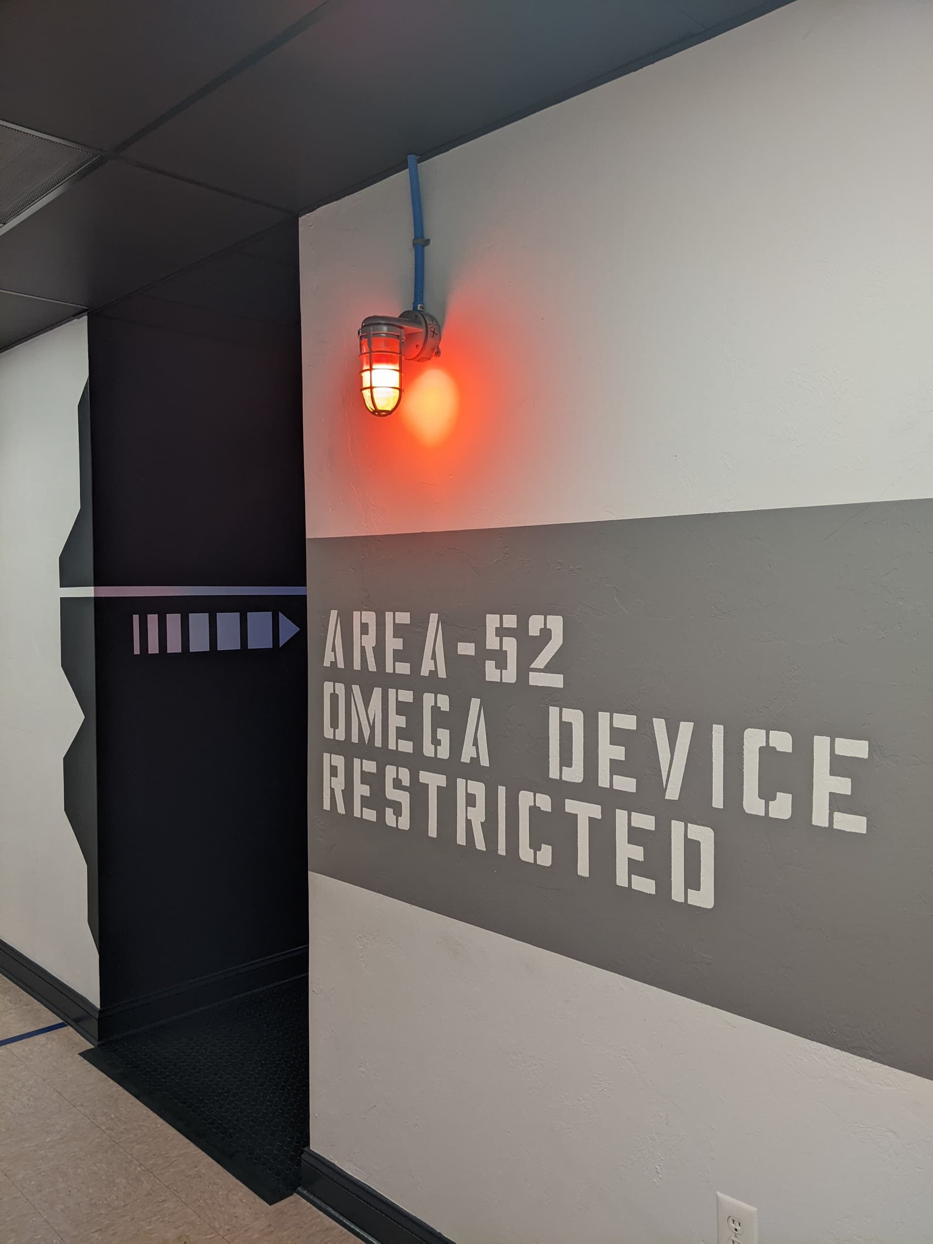 Dim corridor marked AREA-52 leading into sci-fi escape room