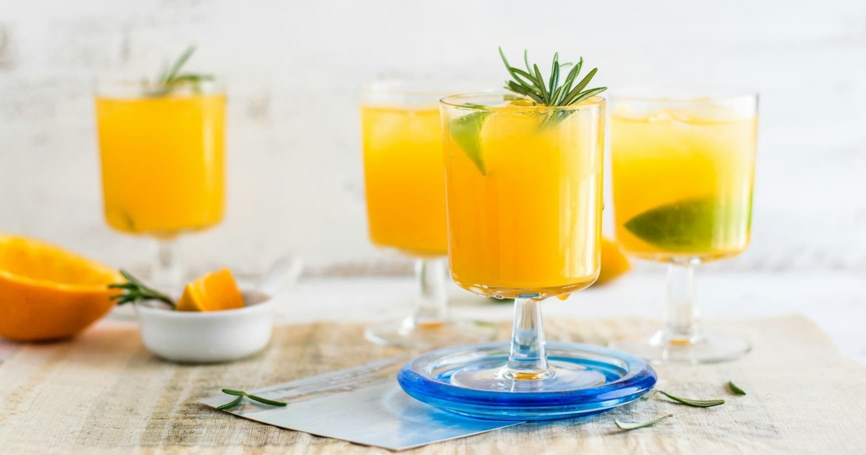 Fresh citrus cocktails styled on table in bright studio