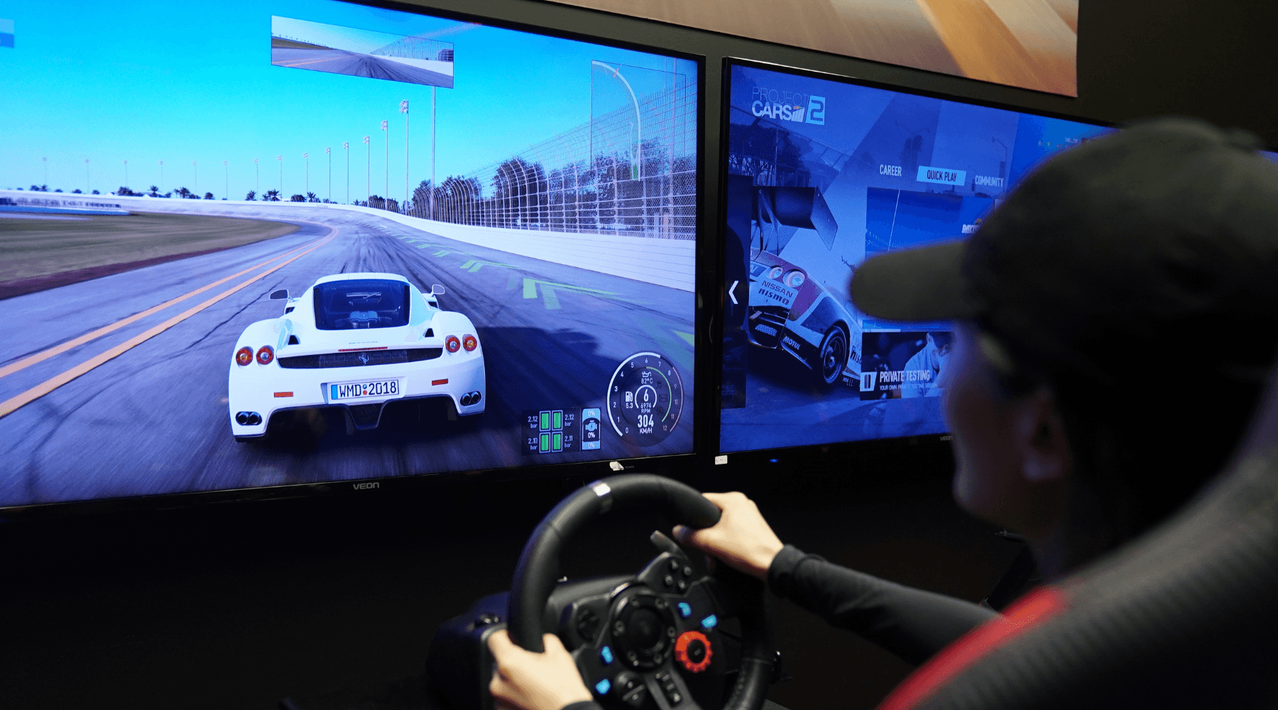 Driver using immersive racing simulator with panoramic screens