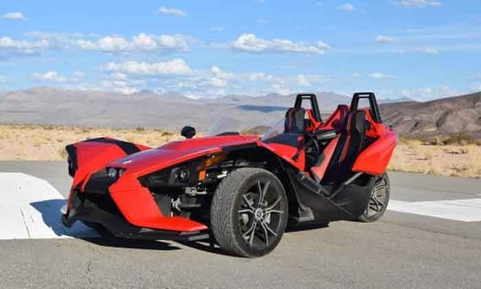 Open-air three-wheeled Slingshot on desert highway for scenic drive