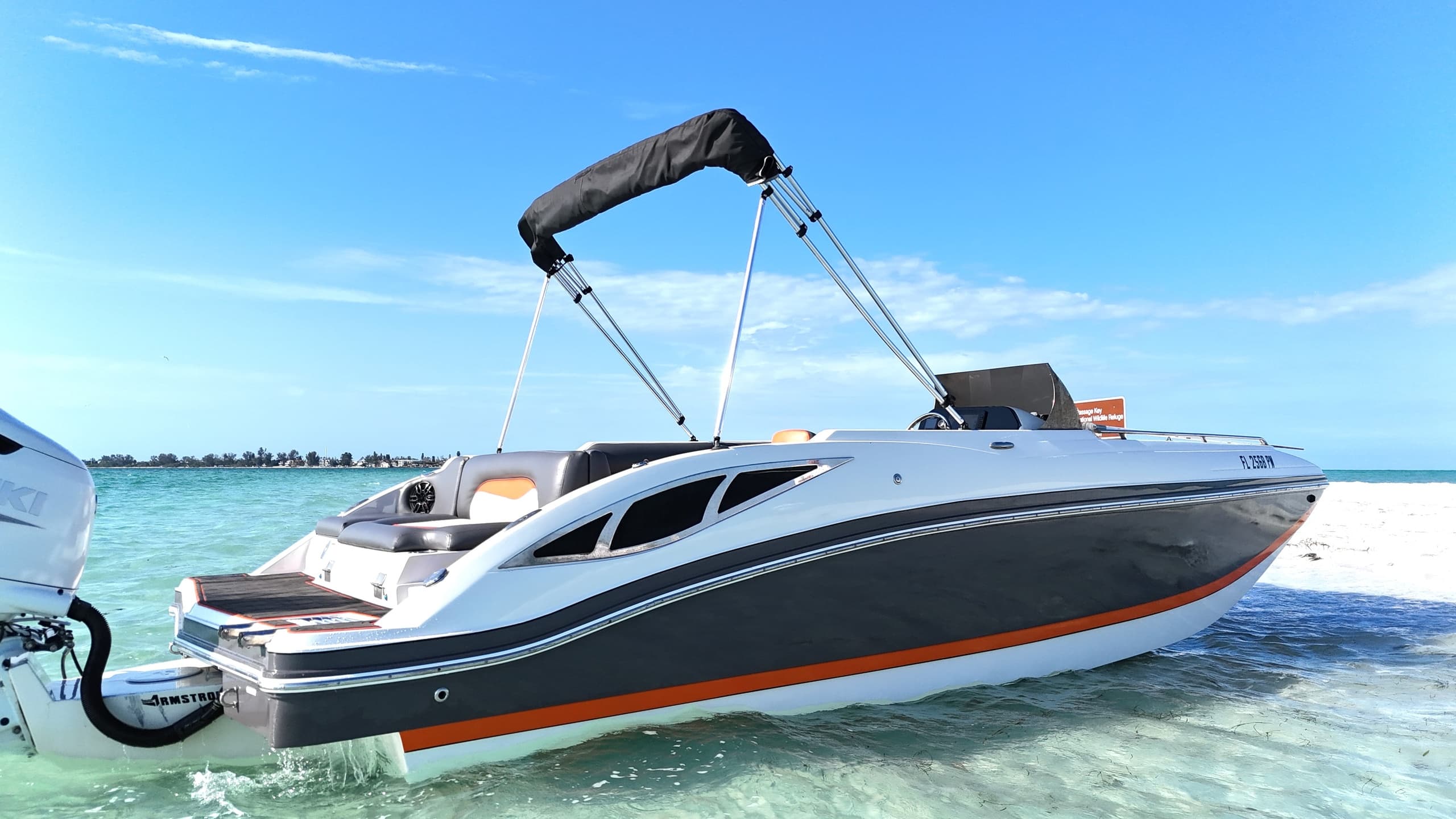 Speedboat in shallow turquoise water, sunny coastal boat ride