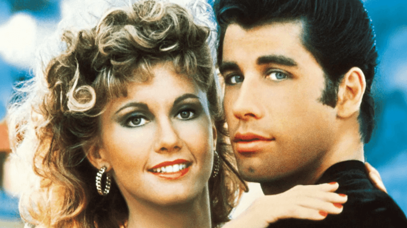 Close-up of couple posing together in retro outdoor fairground setting