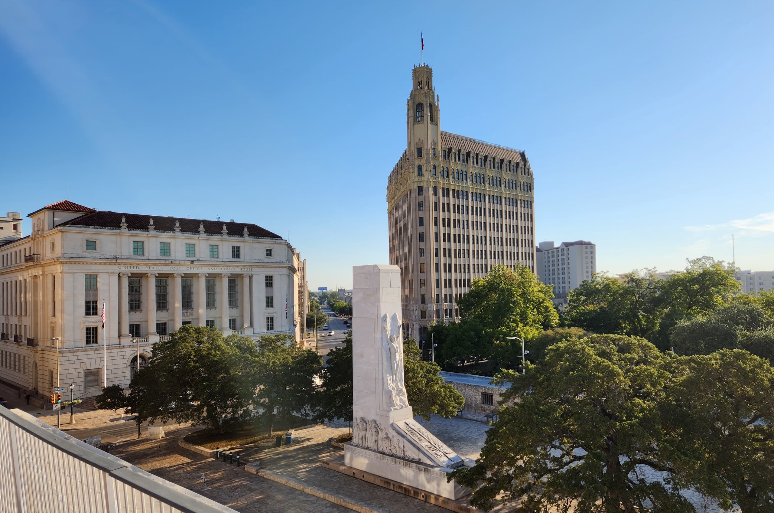 Downtown skyline and monument overlooking urban park in San Antonio