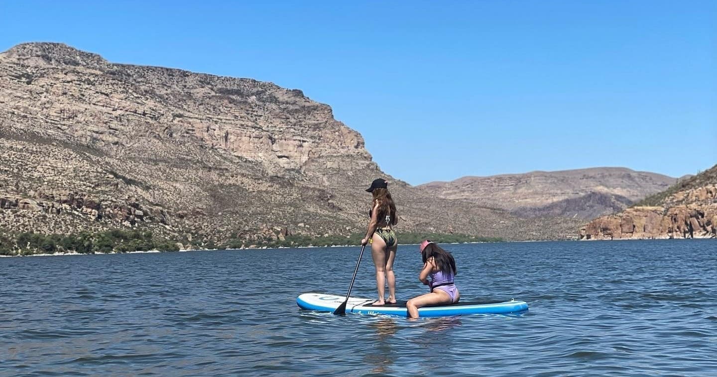 People paddleboarding on Apache Lake with canyon backdrop