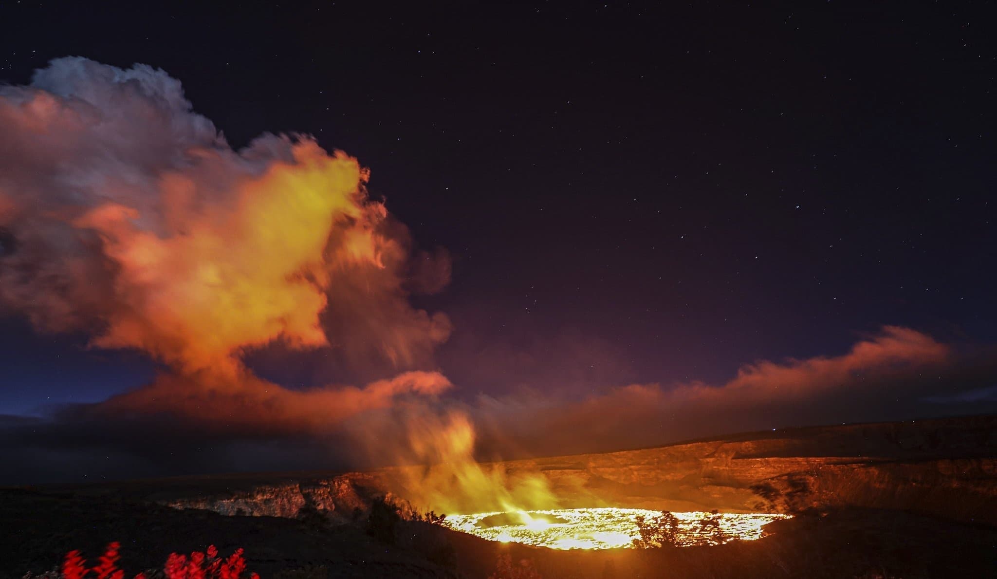 Volcanic lava glowing in crater at night on Big Island Hawaii