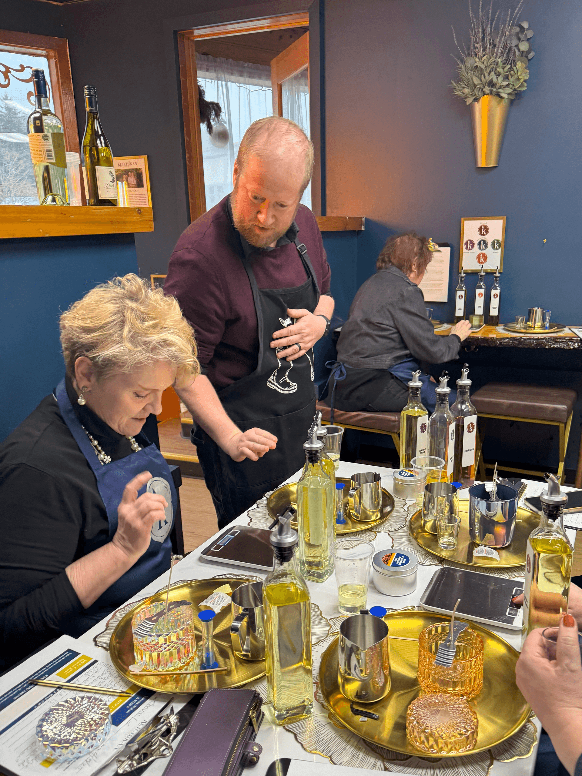 Customers sampling scented candles in indoor candle workshop