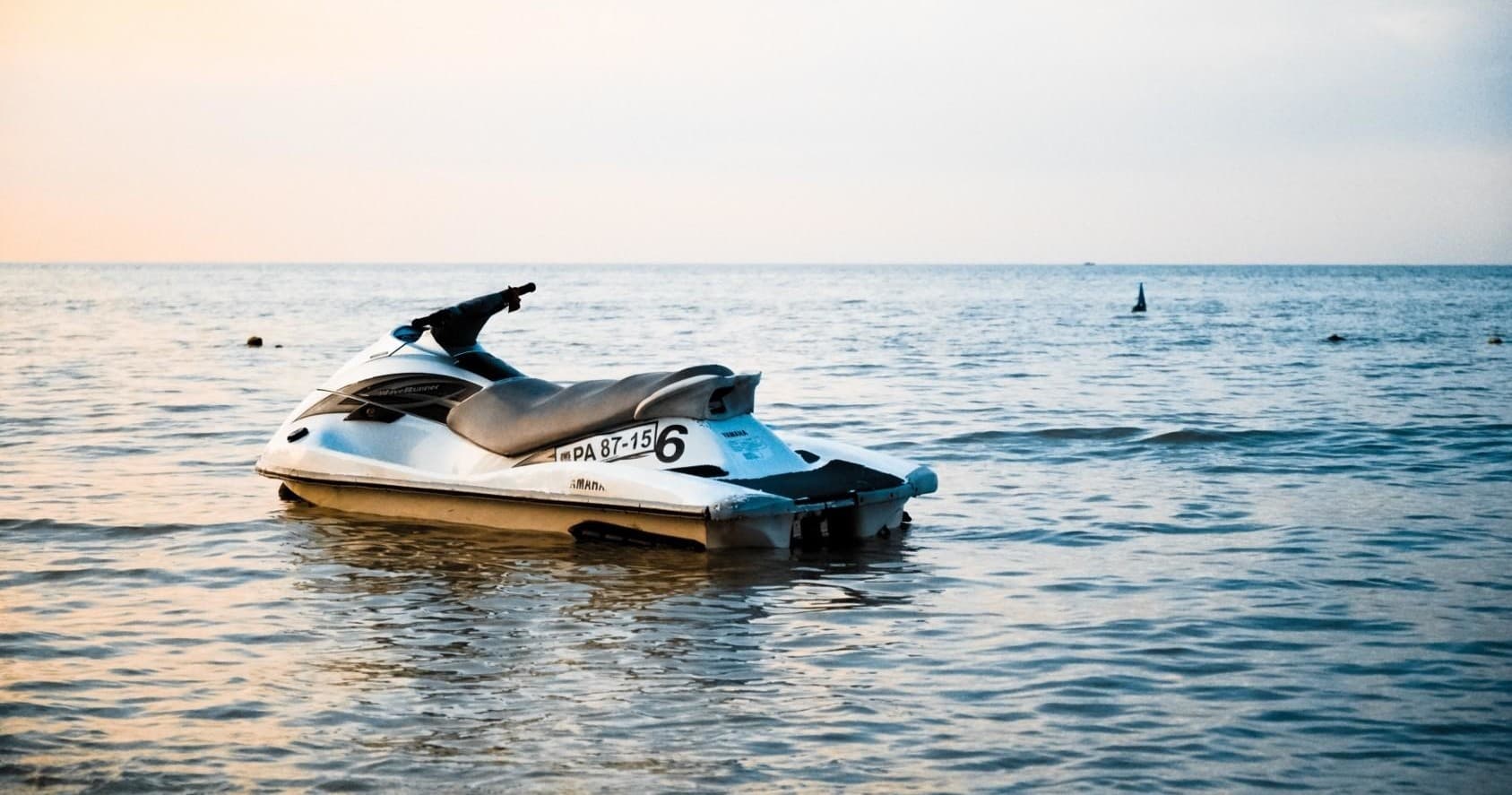 Jet ski on calm ocean at sunset ready for rental ride