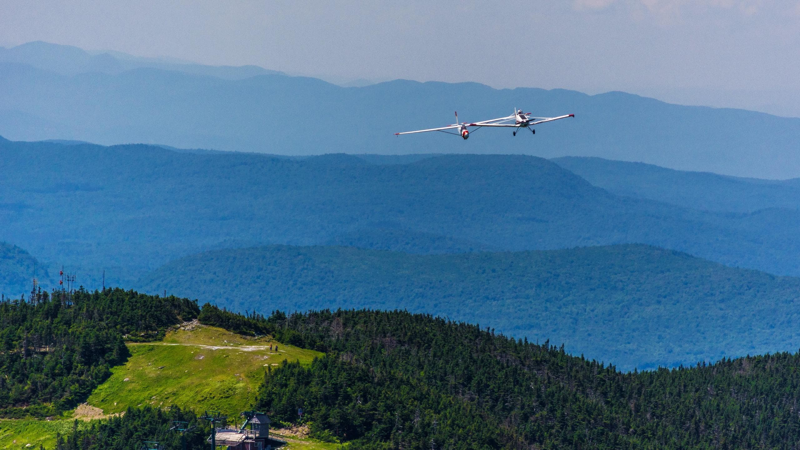 Small plane flying over Mad River Valley mountains scenic aerial