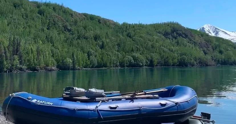 Inflatable raft moored on serene alpine lake for rafting trip