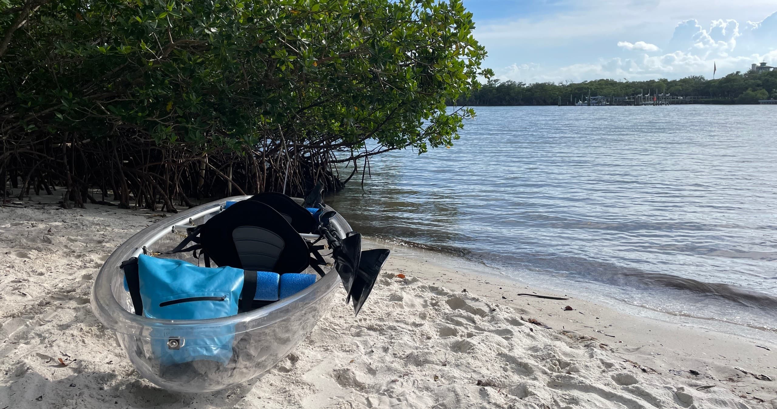 Clear kayak on sandy mangrove beach, coastal kayaking tour