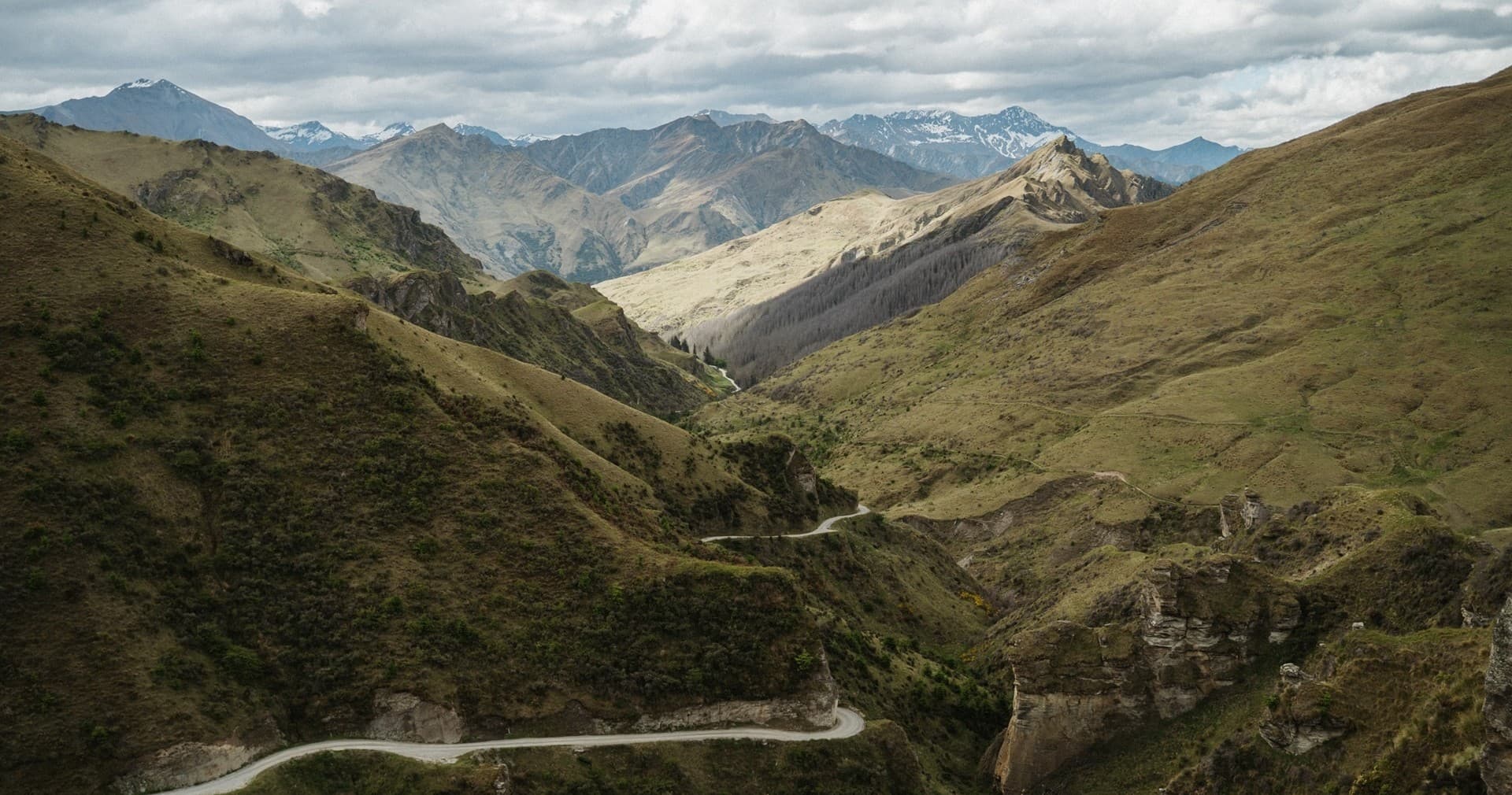 Scenic mountain valley with winding alpine road for scenic drives
