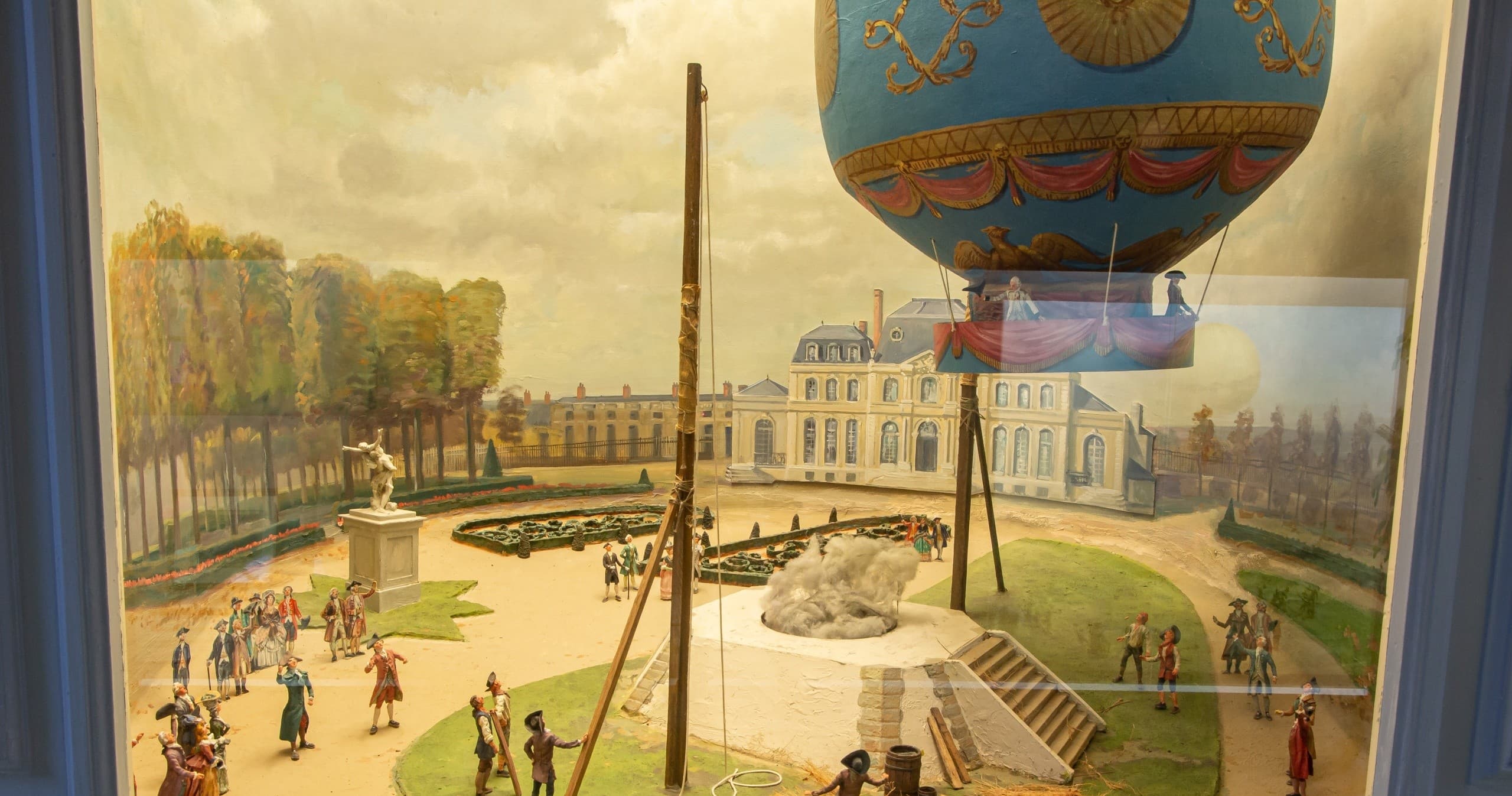 Vintage hot-air balloon painting depicting château gardens scene