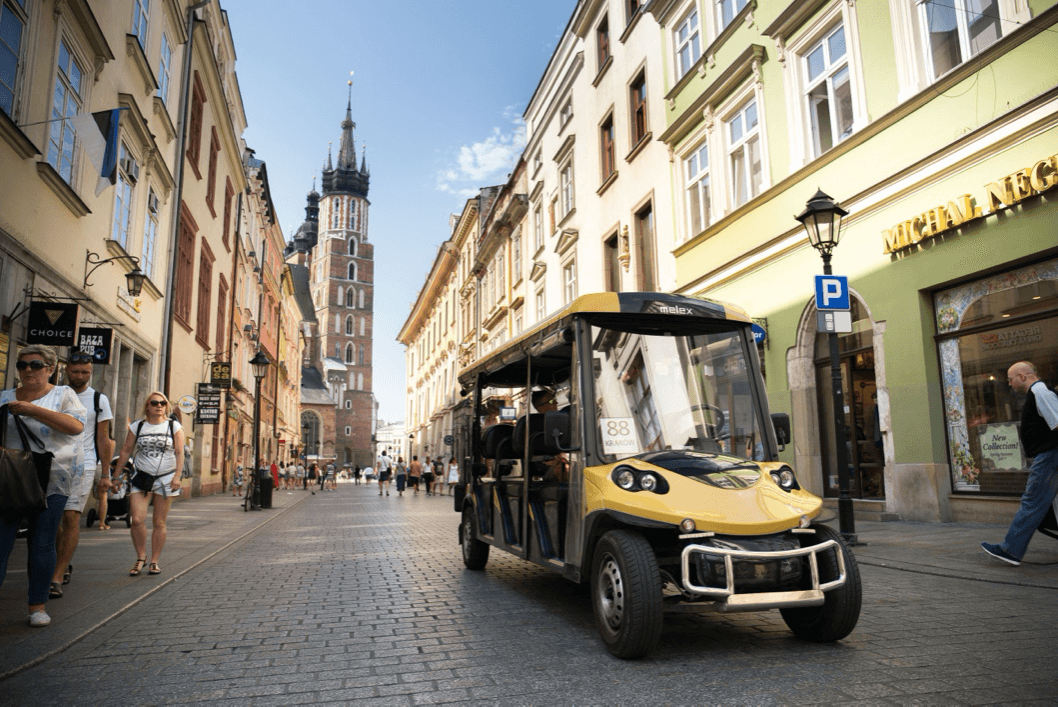 Historic old-town street with open-top sightseeing golf cart tour