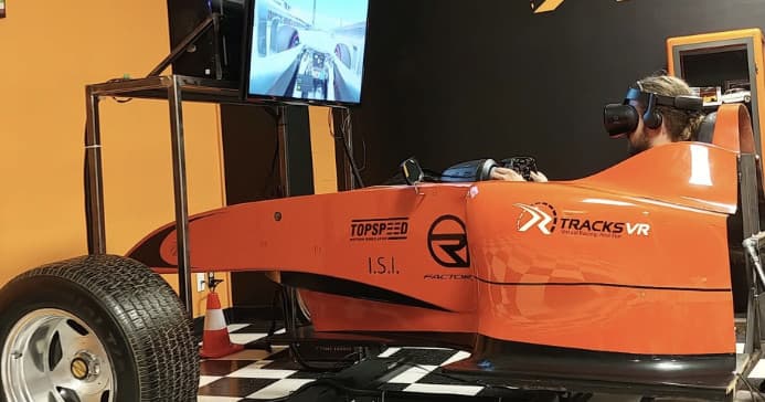 Close-up formula-style VR racing cockpit displayed indoors