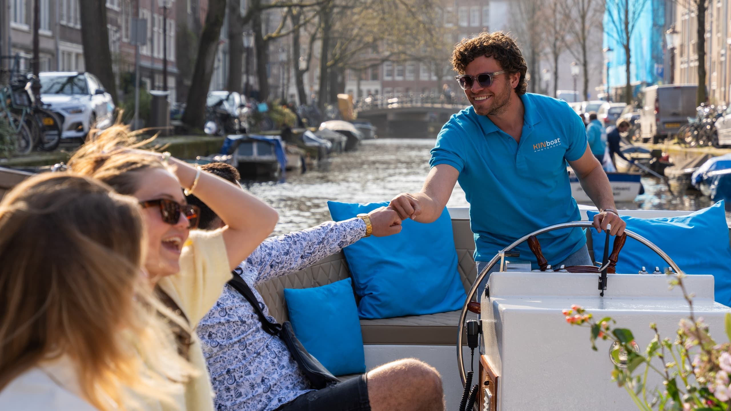 Guests relaxing on private canal boat with guide in Amsterdam