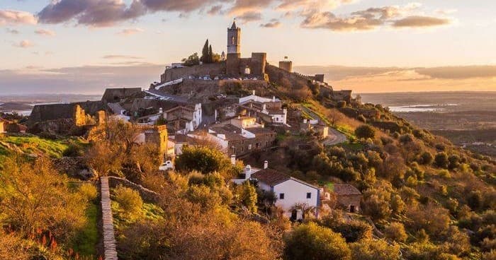 Hilltop medieval village and castle at sunset for scenic hikes