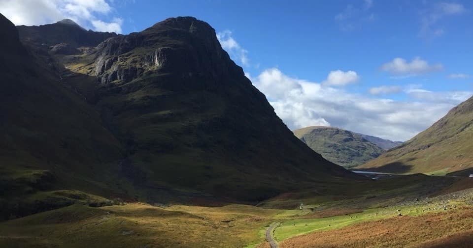 Hikers exploring remote mountain valley, scenic Glen trail