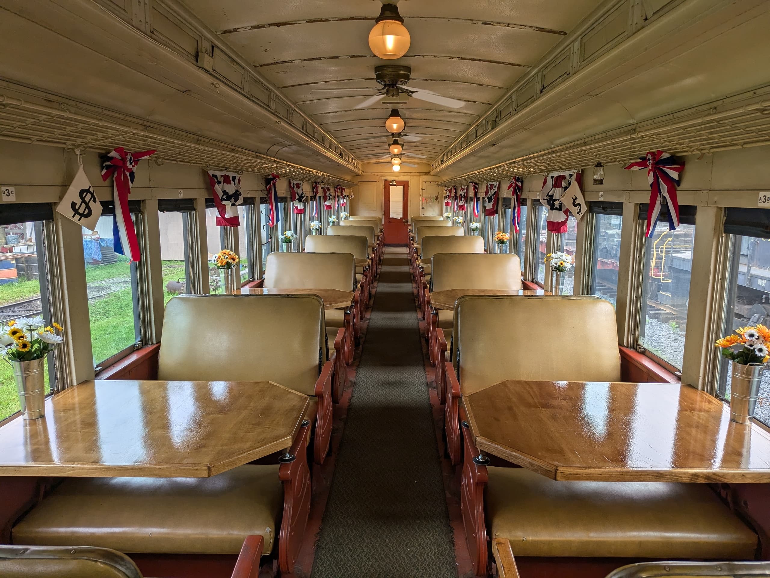 Dining car aisle leading to front with countryside views out windows
