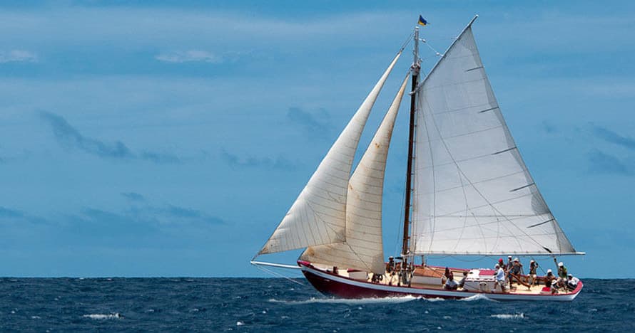 Traditional sailing yacht under full sails on open ocean