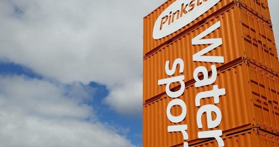 Pinkston water sports signage beside urban canal under sky