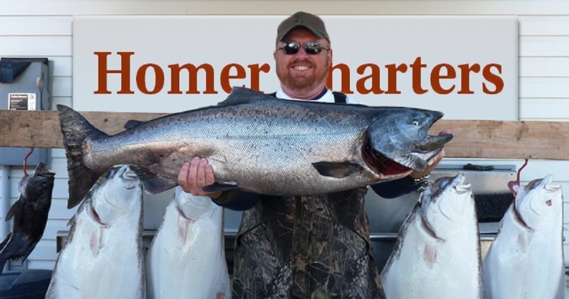 Angler holding large king salmon at Homer Charters dock