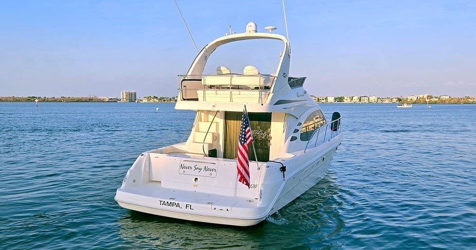 Aft view of motor yacht anchored in tranquil harbor waters