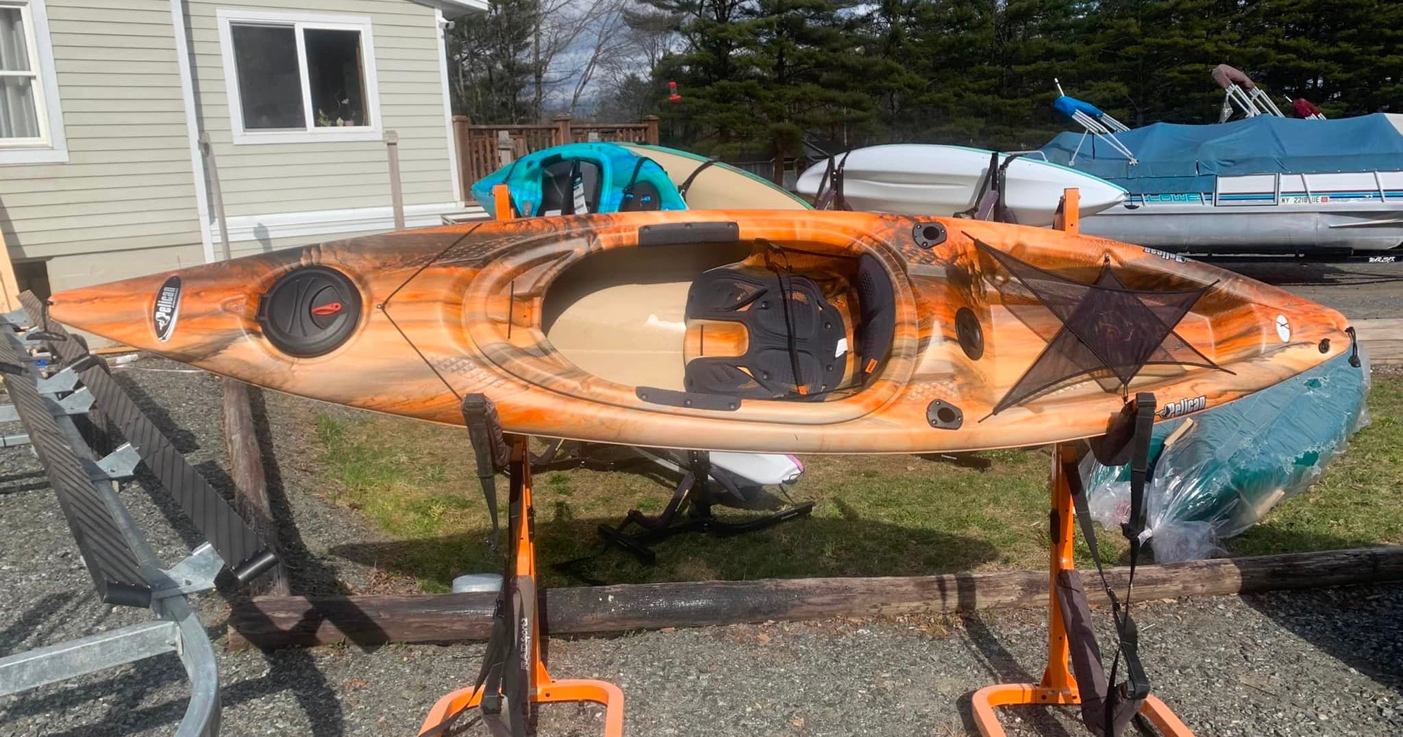 Recreational kayak on stand outside marina, ready for launch