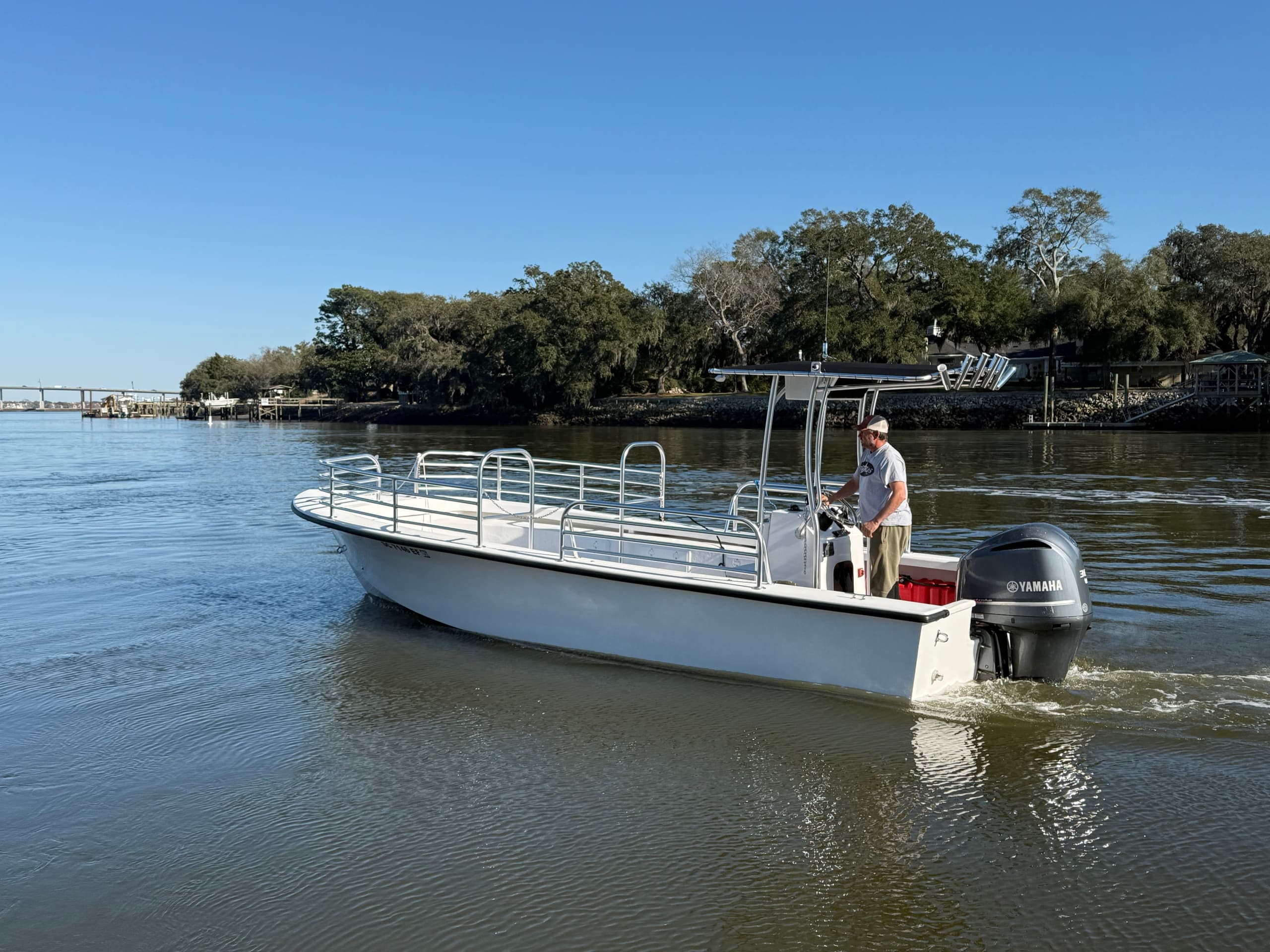 Small excursion boat on calm estuary water, coastal wildlife tour