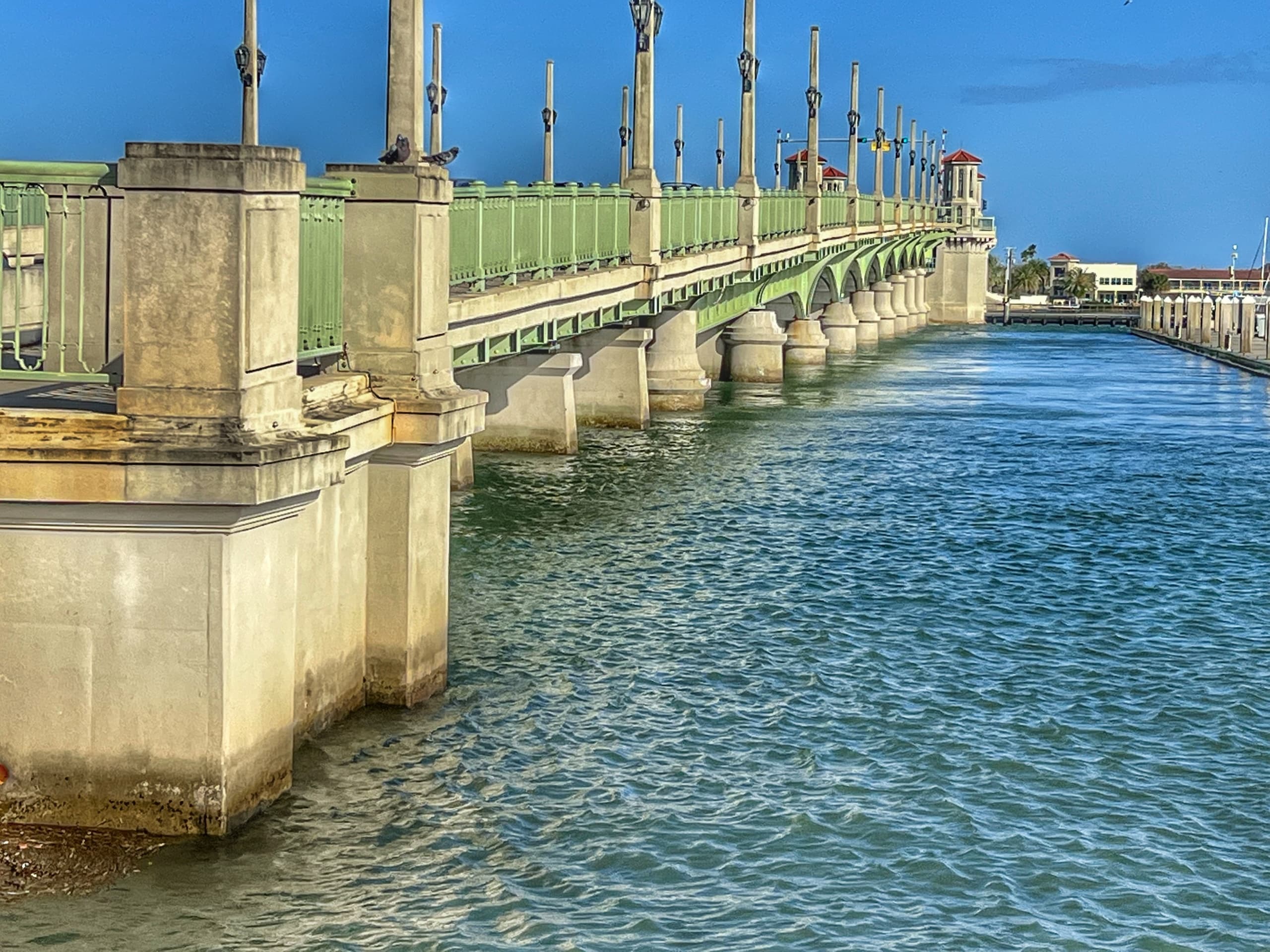 Historic waterfront bridge spanning blue inlet in St. Augustine