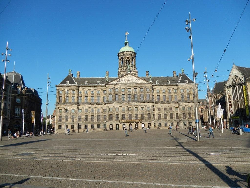 Open Dam Square panorama in Amsterdam showcasing historic palace