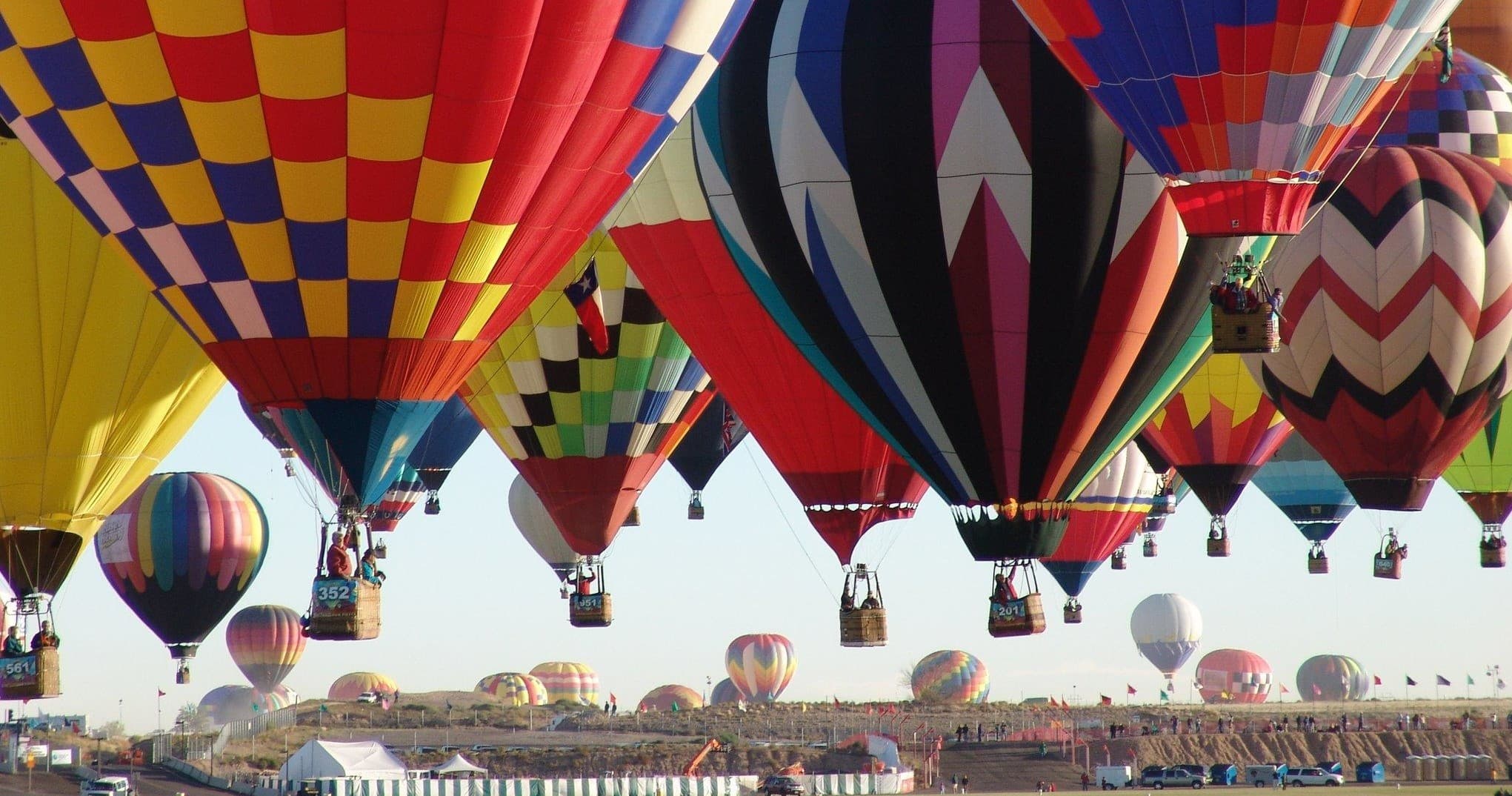 Colorful hot air balloons inflating at festival launch field