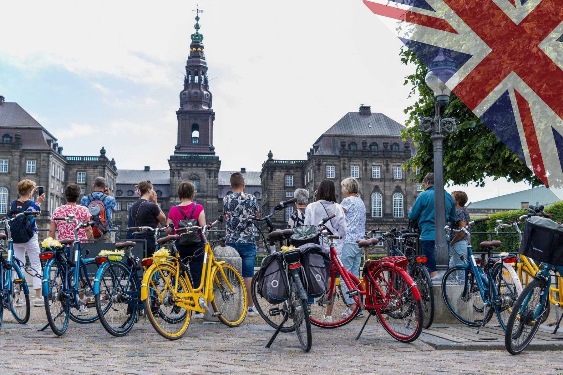 Colorful rental bikes parked by historic Copenhagen square and palace