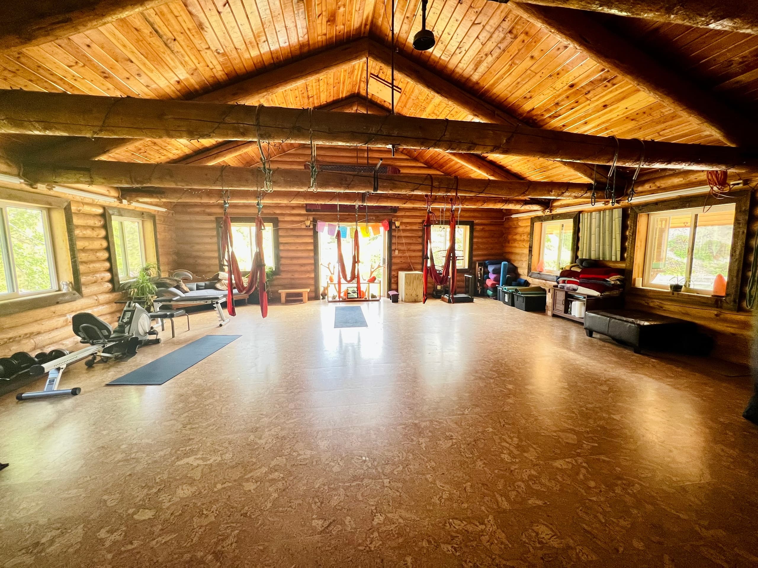 Large cedar community lodge hall with yoga space at Trinity Hot Springs