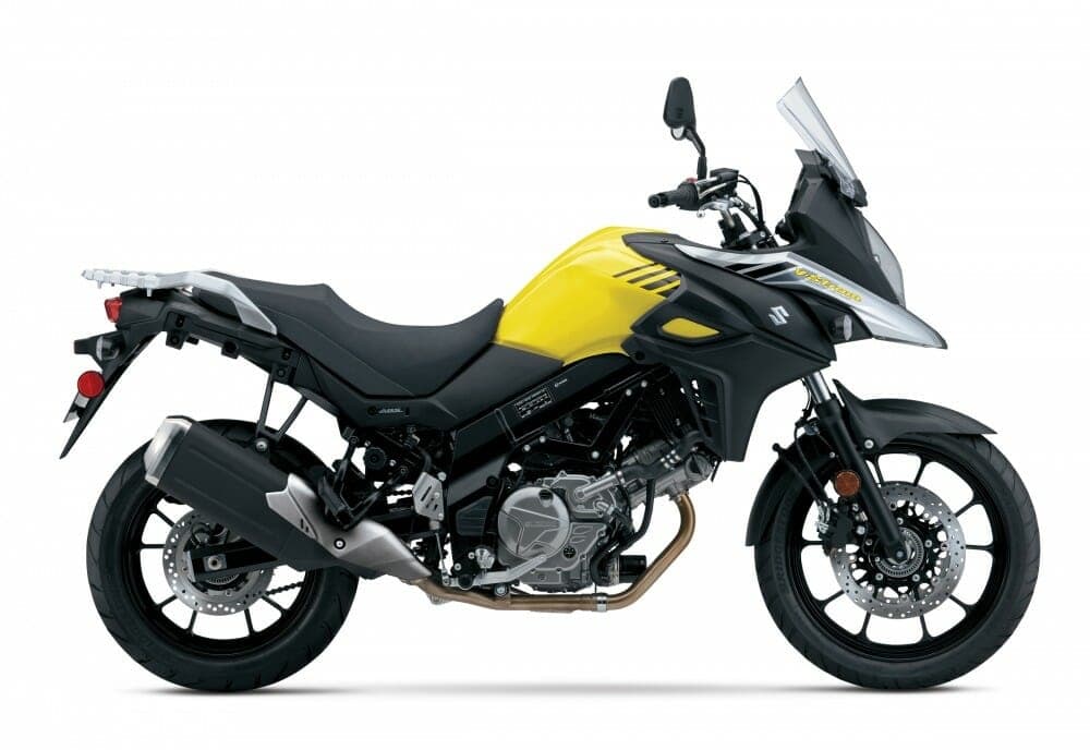 Yellow adventure motorcycle on white backdrop, ready for touring