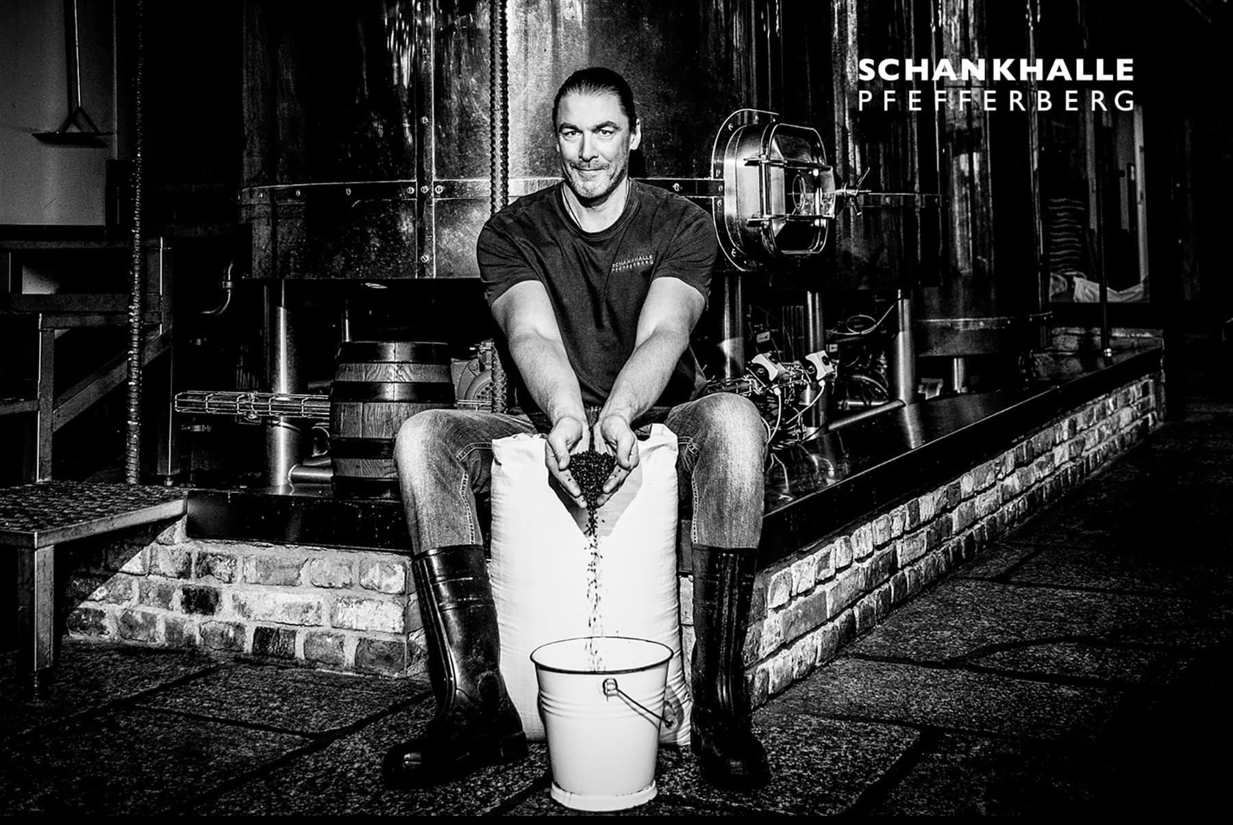 Brewer handling beer brewing tools at Schankhalle Pfefferberg