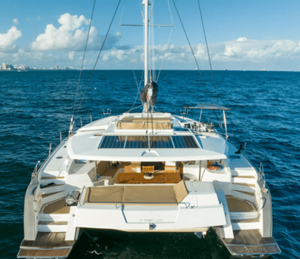 Catamaran sailing on open ocean, leisure cruising off coast