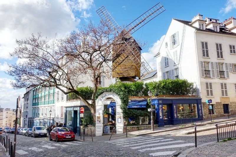 Montmartre windmill and street cafe in Paris scenic neighborhood