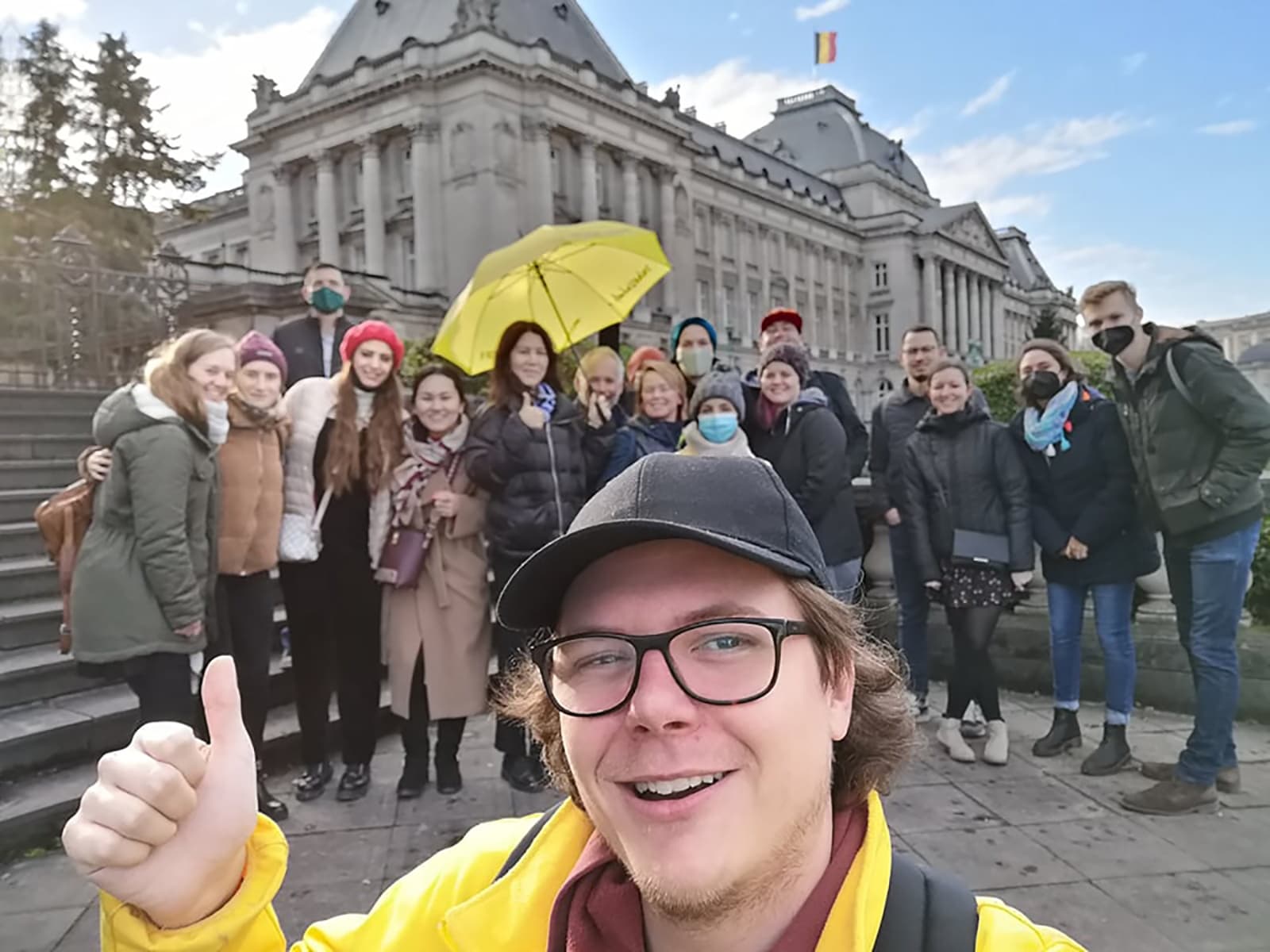 Guide selfie with tour group at grand city square in daytime