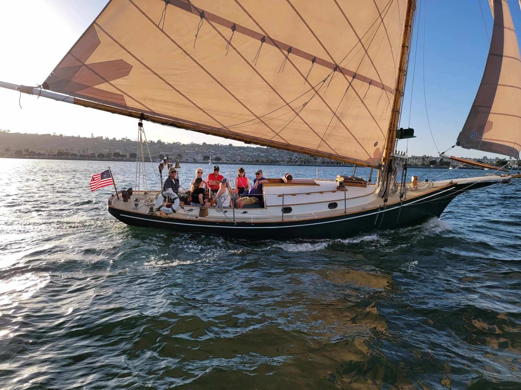 Group sailing aboard classic yacht on calm coastal waters