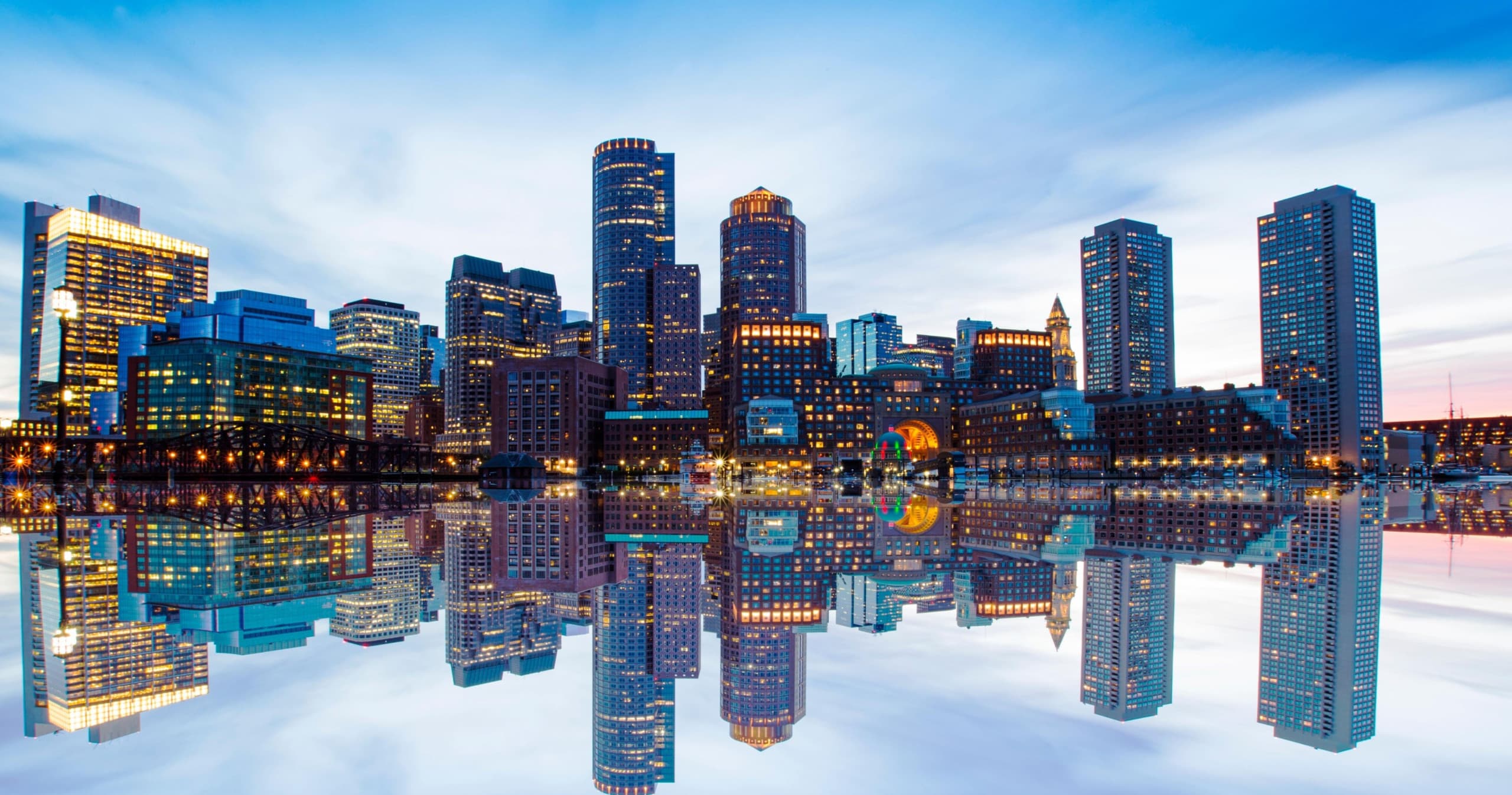 Dusk waterfront skyline reflected in water, cityscape panorama