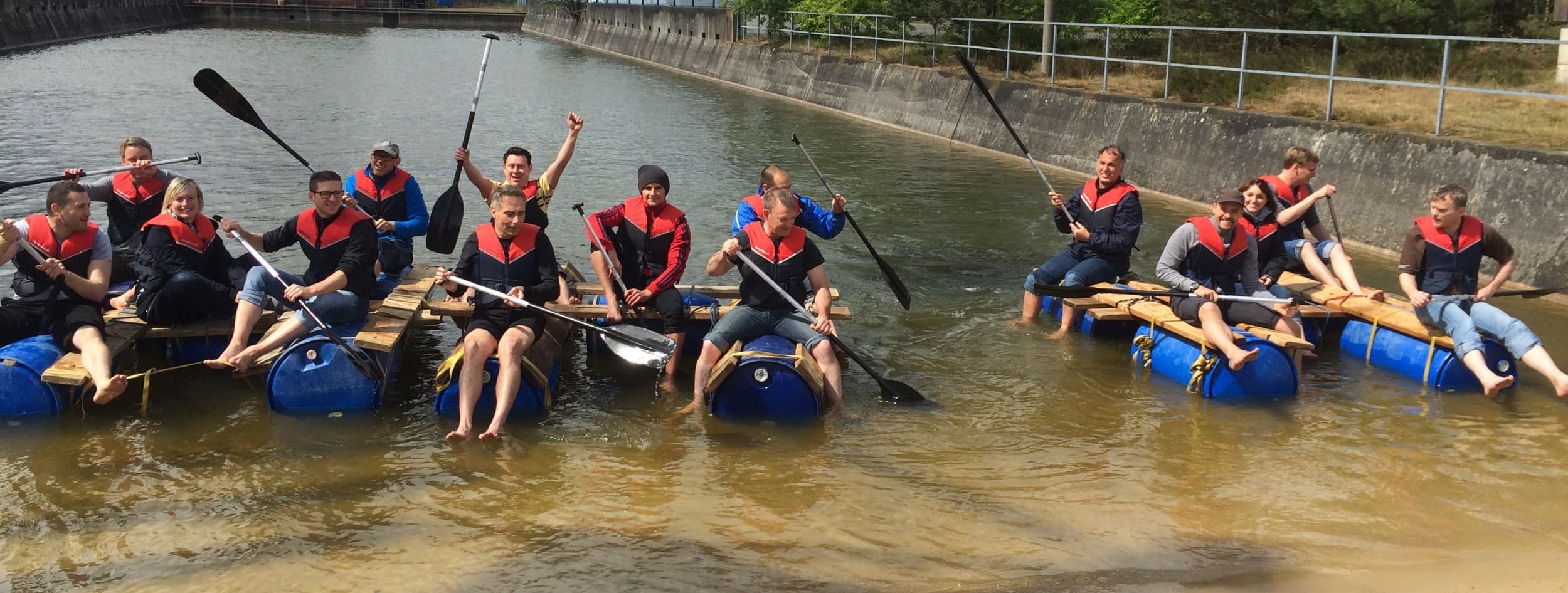 Team rafting on a calm river during guided outdoor paddling trip