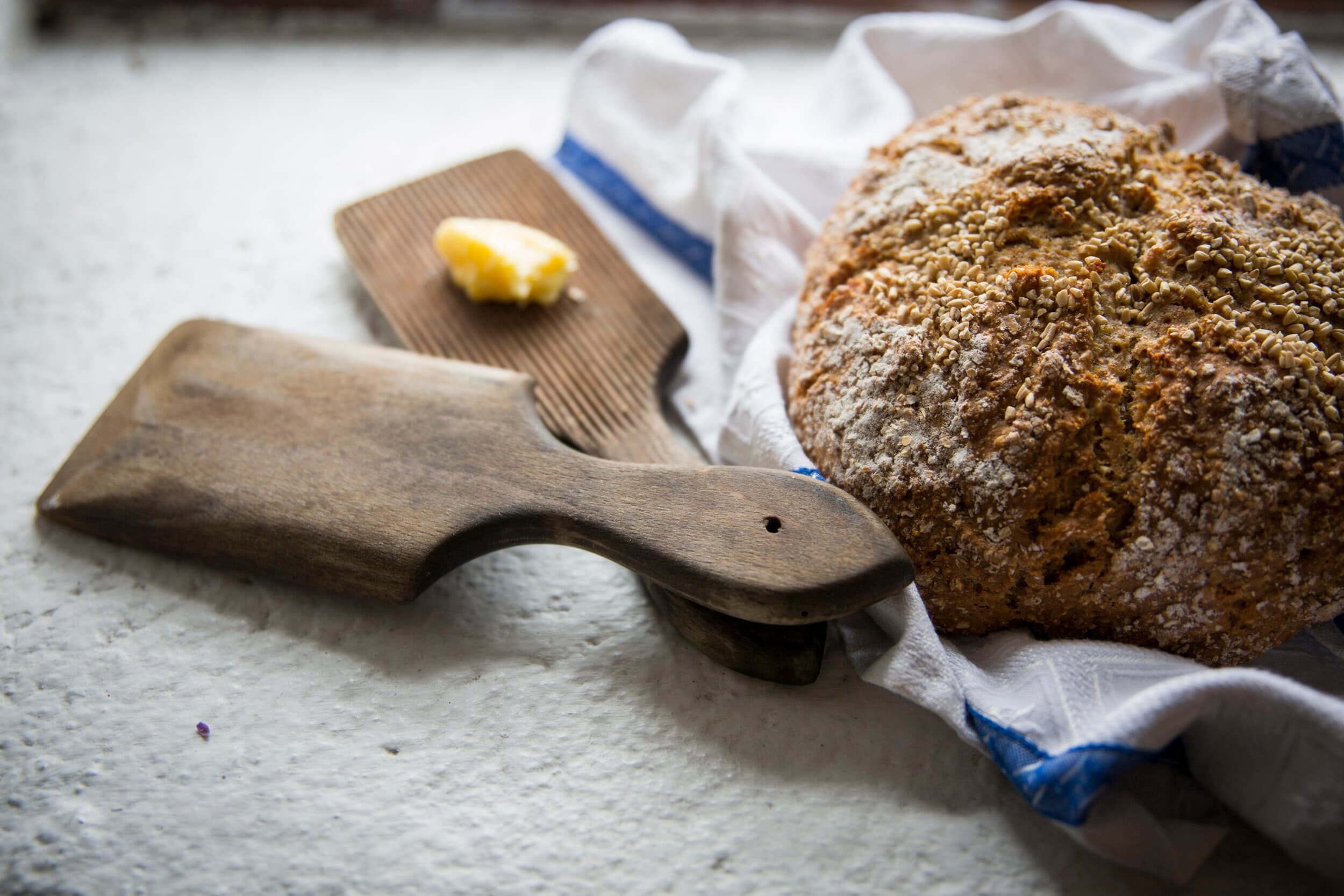 Baking: fresh Irish soda bread on wooden board in rustic kitchen