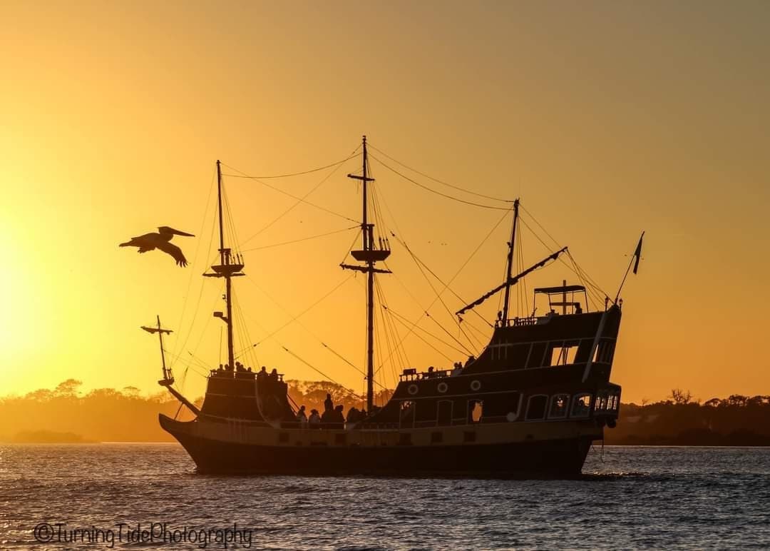 Pirate ship sailing at sunset off St. Augustine coast