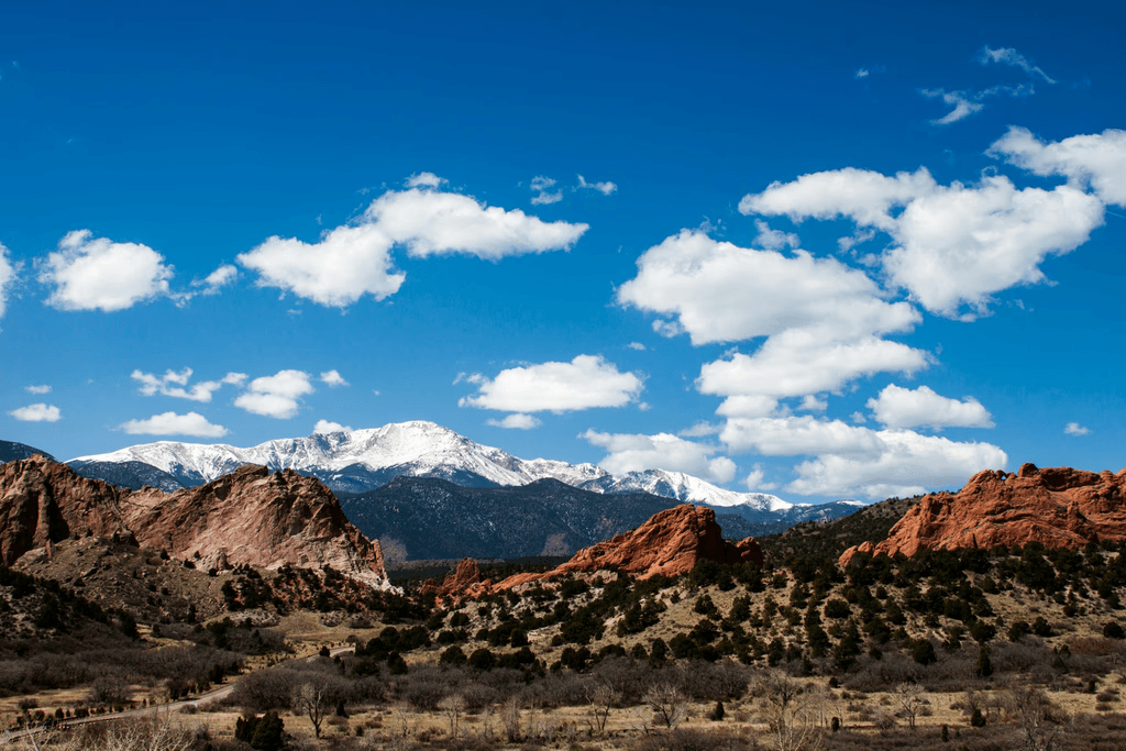 Panoramic red-rock mountain landscape under bright blue sky