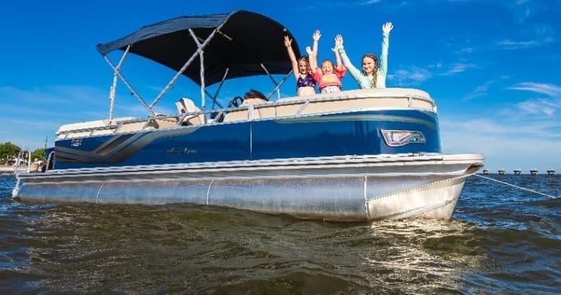 Family enjoying pontoon boat cruise on Biloxi coastal waters