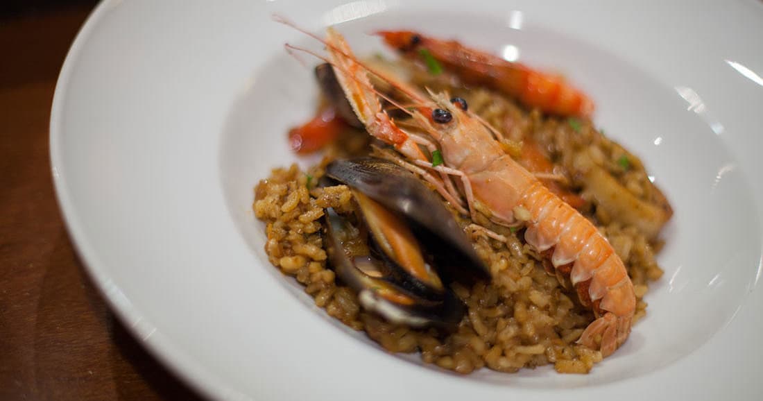 Seafood paella plate with prawns and mussels at Barcelona restaurant