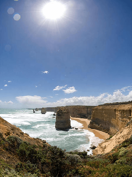 Sunny cliff-top view over ocean and sea stacks on coastal route
