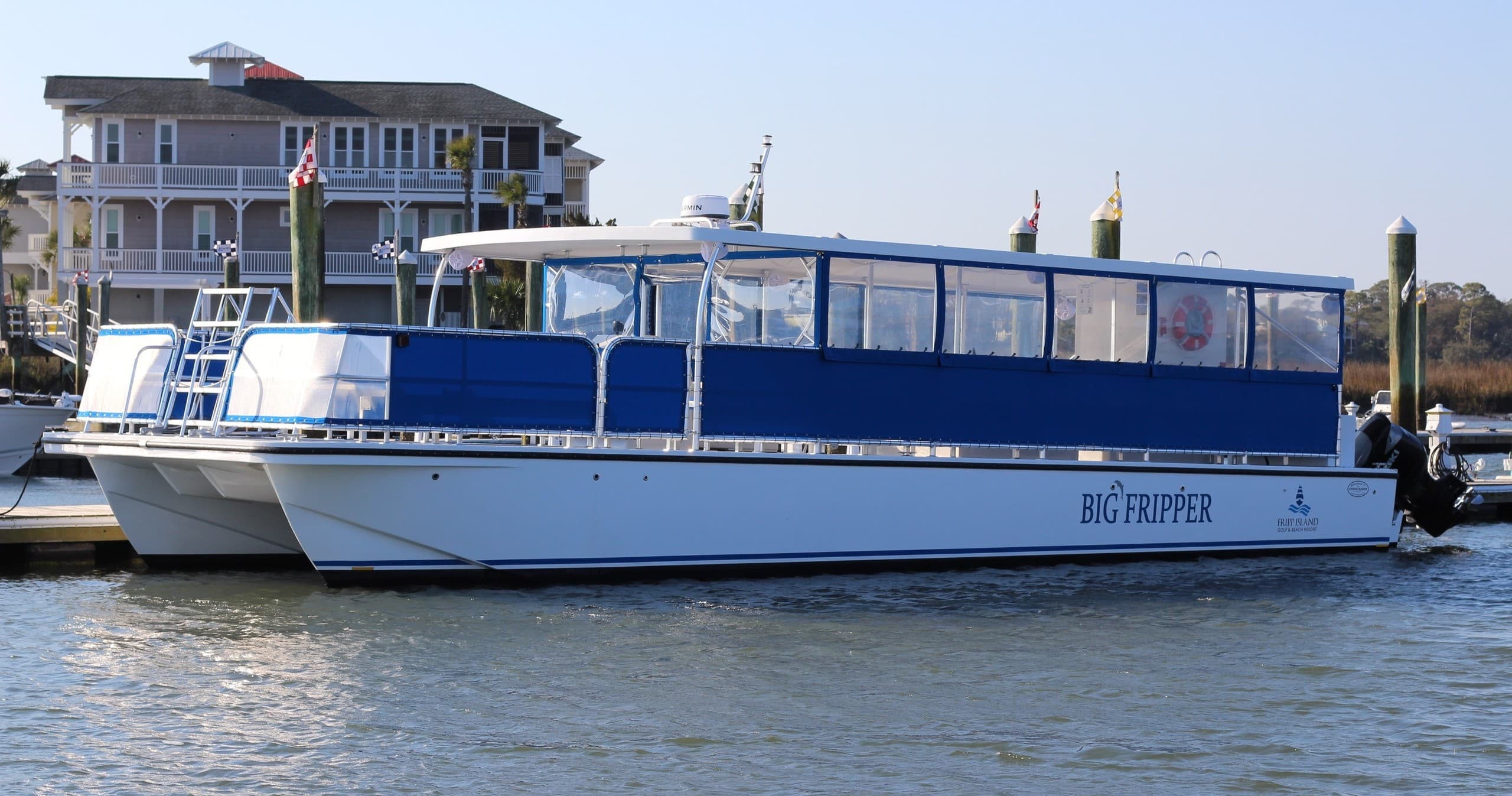 Blue passenger ferry moored in harbor, coastal sightseeing boat