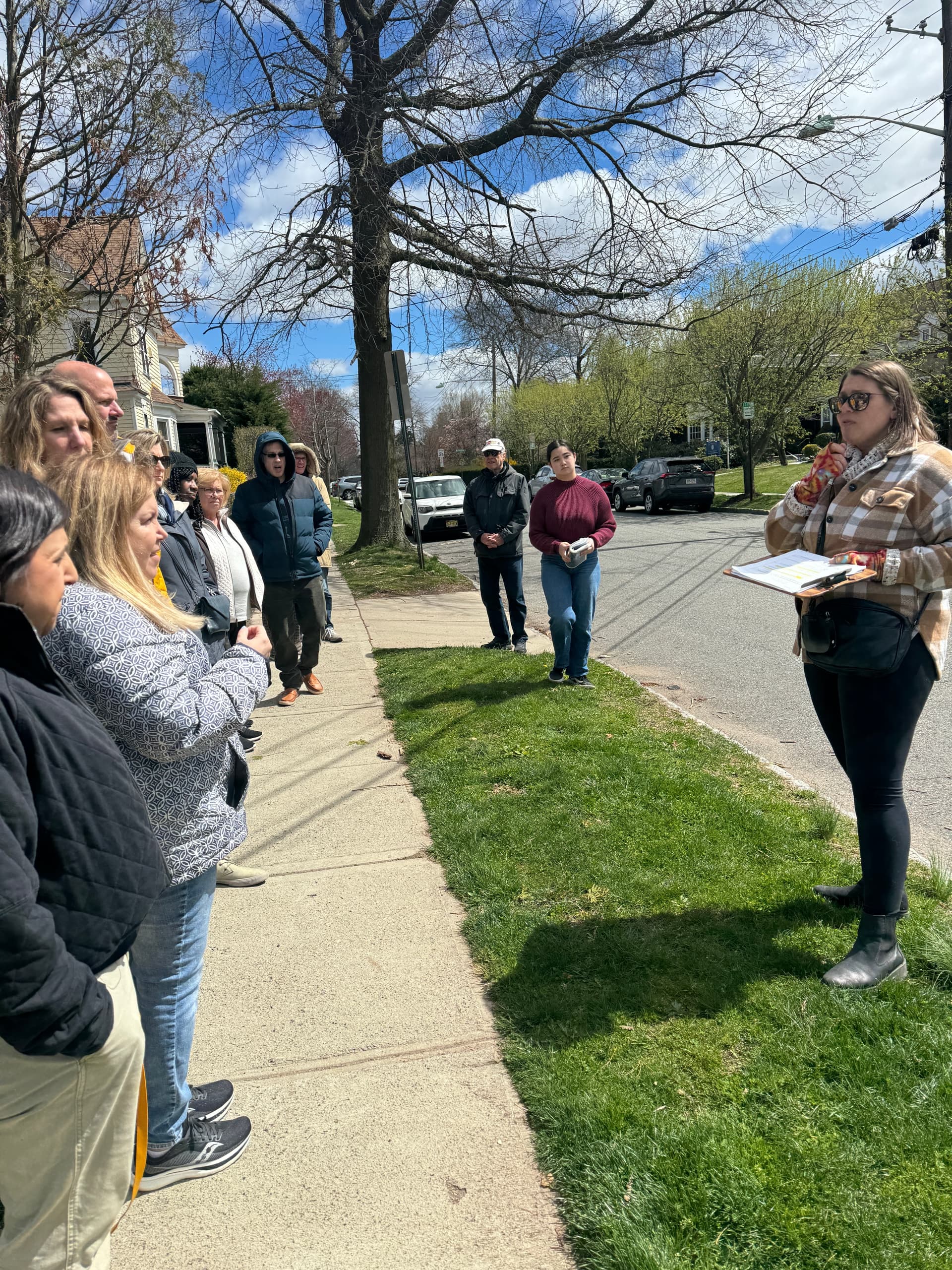 Neighborhood walking food tour with guide on residential sidewalk