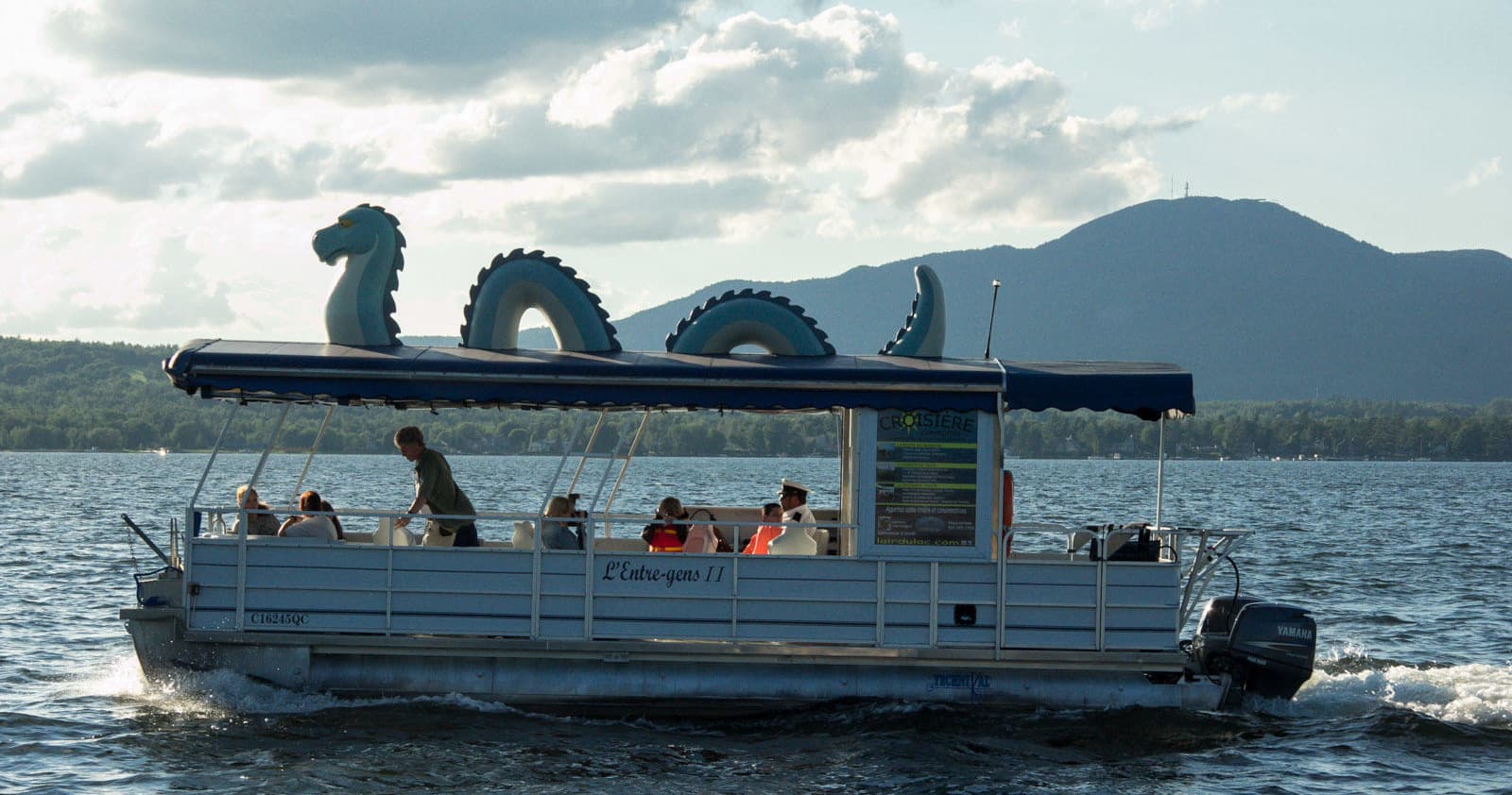 Pontoon boat with inflatable dragon on Lake Memphremagog